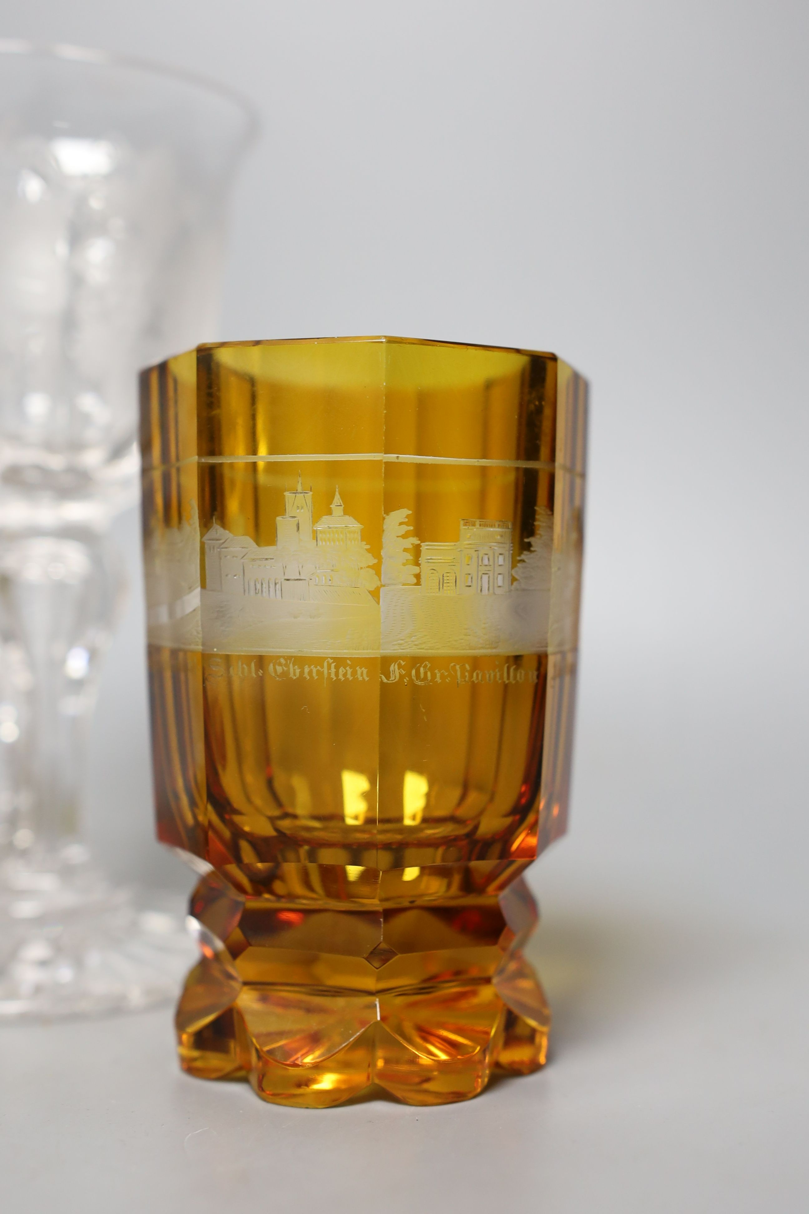 Two Bohemian wheel engraved amber flashed beakers, one with titled topographical views and a wheel engraved glass goblet (3) - tallest 18cm